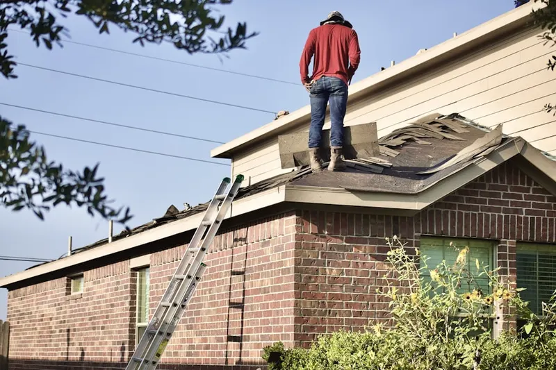 Professional roofer working on a residential roof in Oakwood Farms